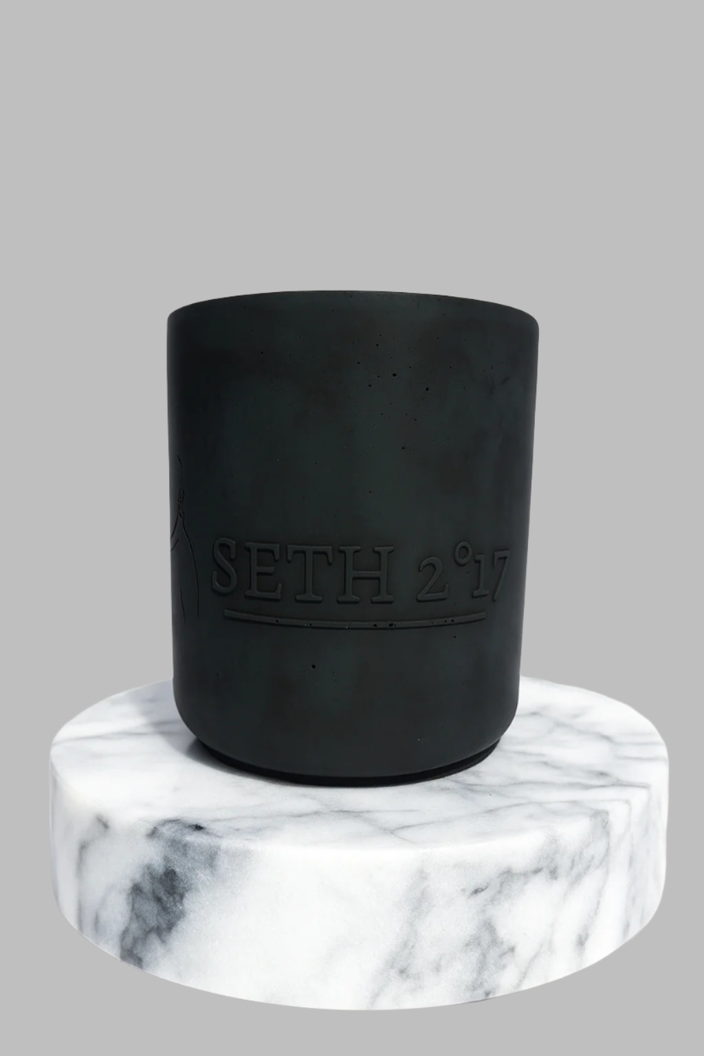 Black container with 'Seth 217' branding on a marble base