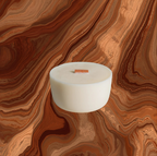 White candle in a glass holder on a brown and orange swirled background